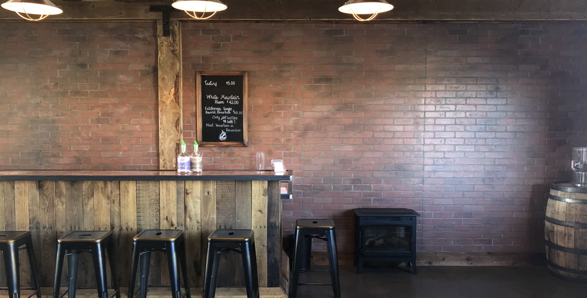 The Devils Creek tasting room — brick, wood bar, and chalkboard